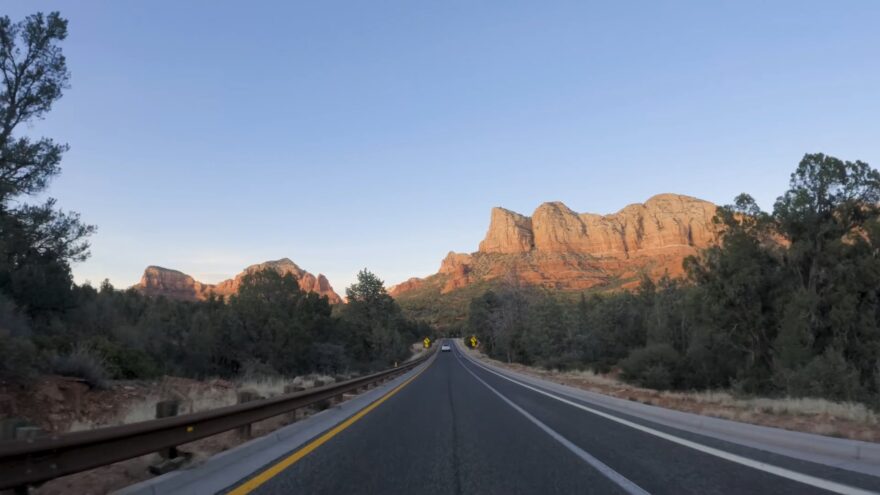 Red Rock Scenic Byway road leading through Sedona red rock formations at sunset